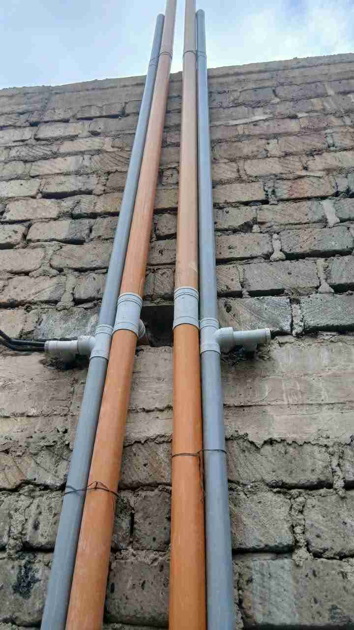 Outdoor Plumbing & Tank Connection — Supply lines clipped and routed along the wall