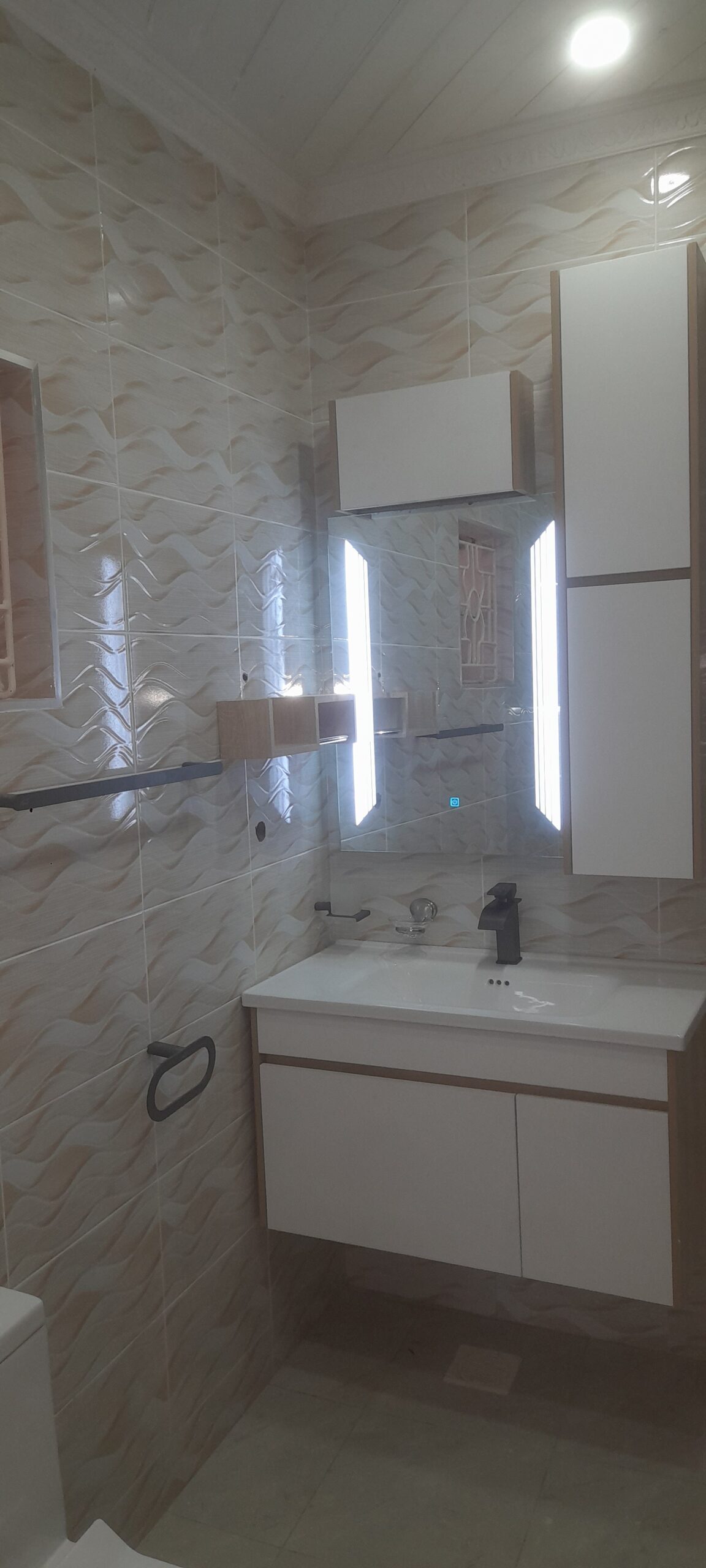 A CareMax bathroom installation — LED mirror cabinet and vanity